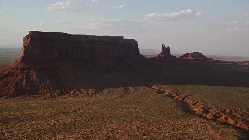A squareshaped rock formation in the middle of the desert
