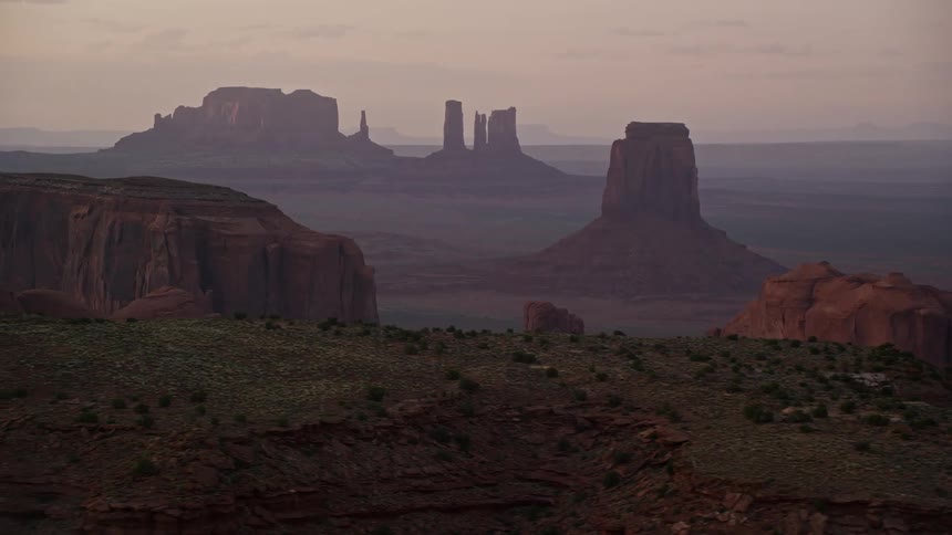 Drone view of rock formations in the desert across the landscape on a hazy day