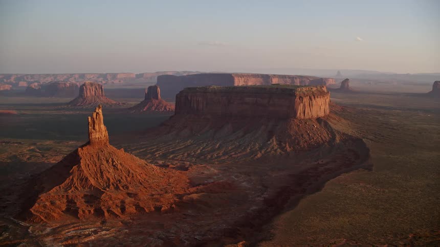 A valley with canyons and cliffs in rocky geological formations at dawn