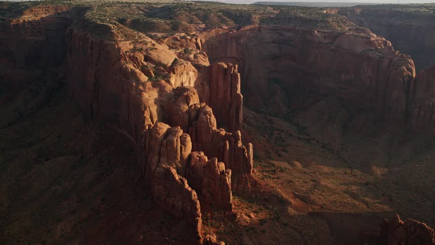 Aerial of mountain cliffs with a plateau on the top in the desert during the day