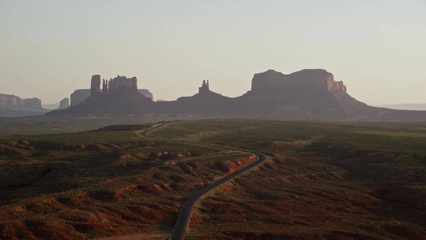 Aerial view of road leading to plateaus in the desert