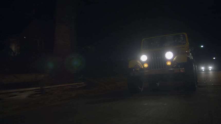 Headlights of a jeep at night