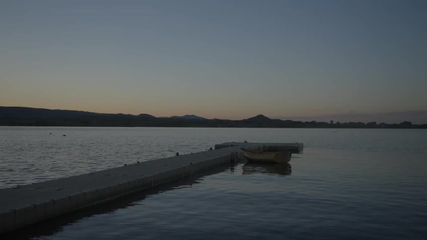 Dawn of the day with a view of a dock on the sea