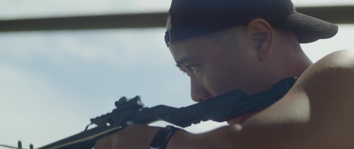 A man looks through the sight of his crossbow before he fires an arrow
