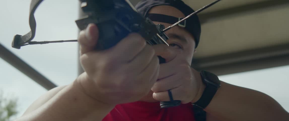 Archer takes aim with a crossbow