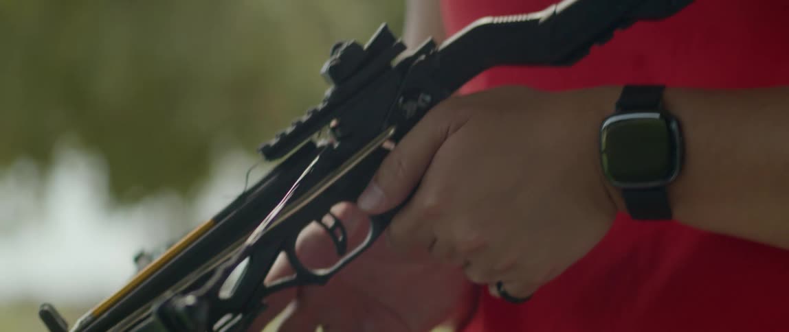 Archer loads a bolt into a crossbow then takes aim and shoots