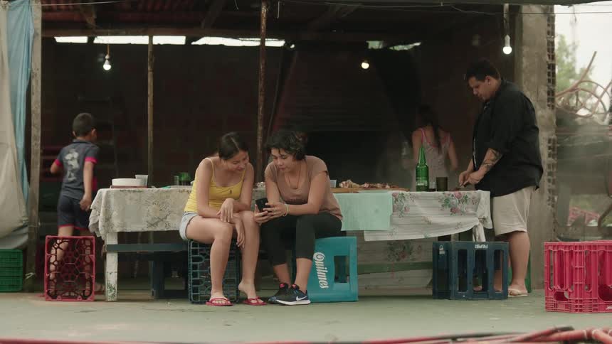 Family sit on a table on a third world restaurant