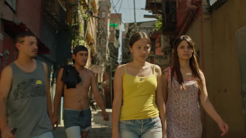Two ladies walking and two men tried to speak with them one lady pushed one of the men away while they continued walking