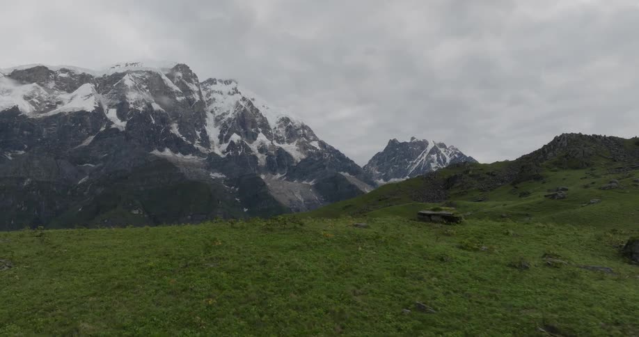 The uneven slope of a mountain covered in vegetation under a cloudy daytime sky