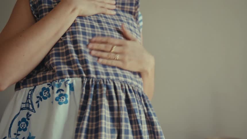 Girl holds dress against herself to check appearance