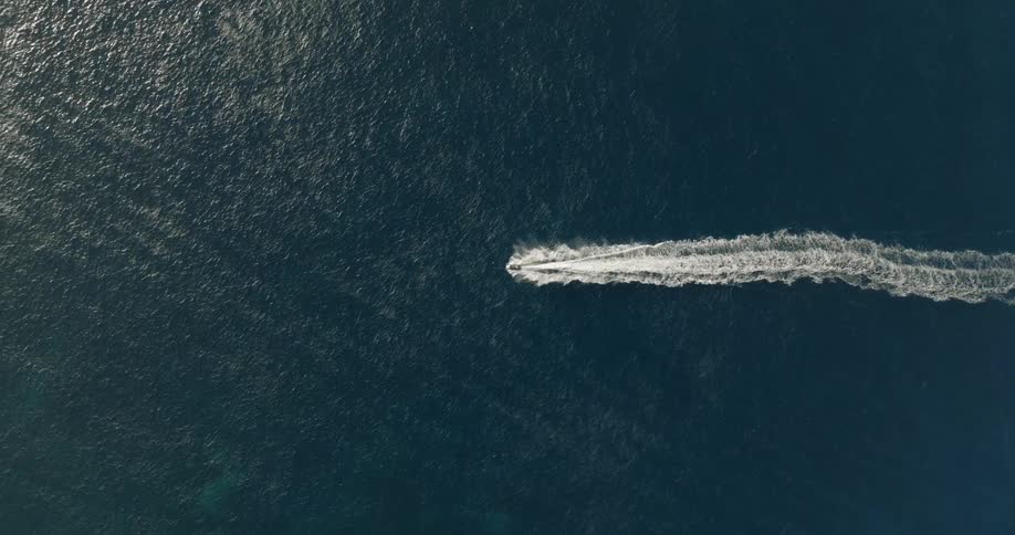 A jet ski moves on the surface of the water and making waves with its movement