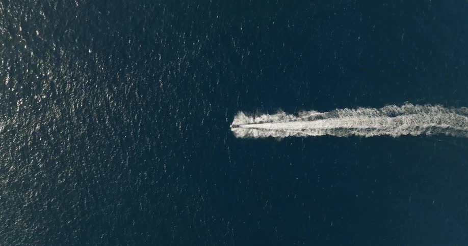 A speed boat is traveling in the ocean
