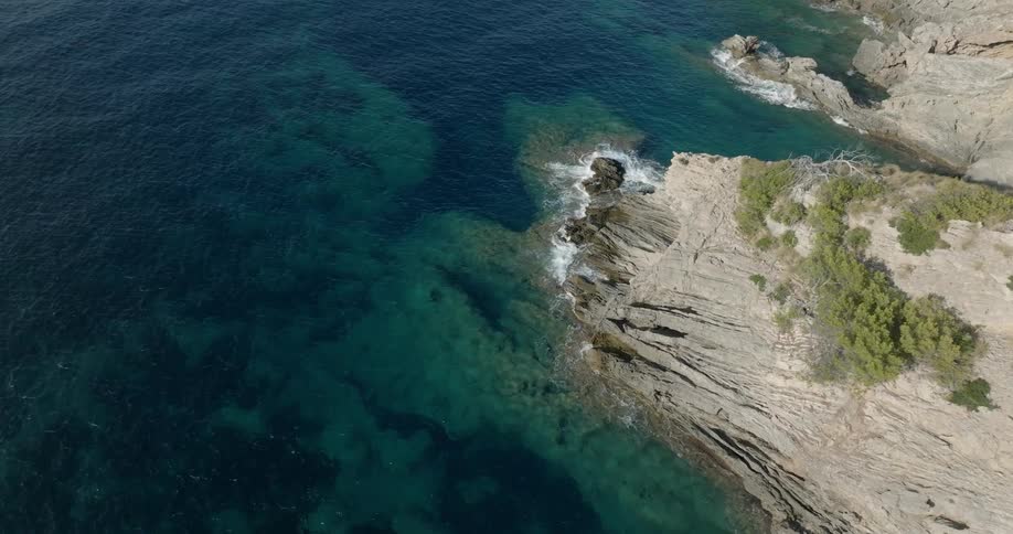 A coastal region of a mountain where sea waves reach the edge