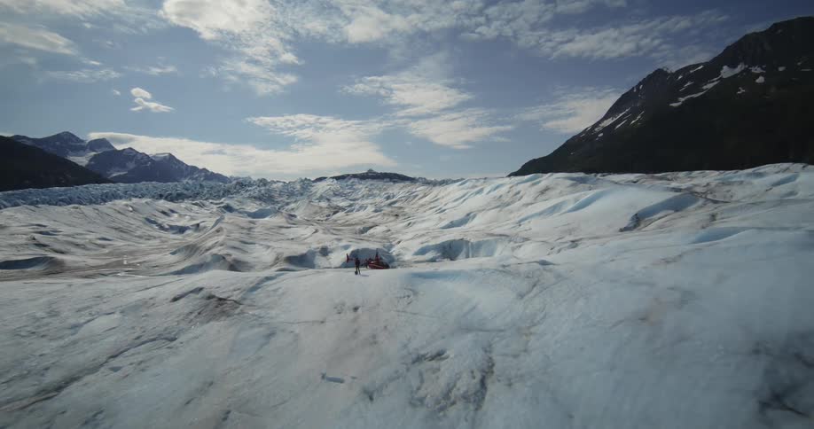 Aerial view of a helicopter parked on the surface of a glacier