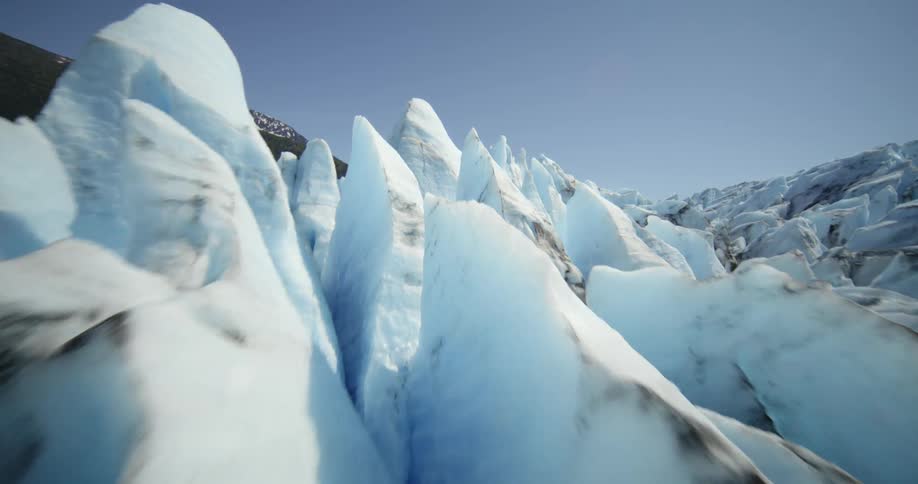 Aerial view of ice peaks on the surface of a glacier in the mountains