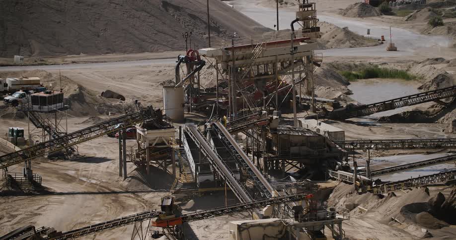 A large industrial machine in a sand field