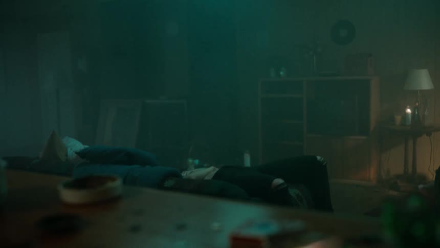 Restless woman walks up and down in dimly lit living room