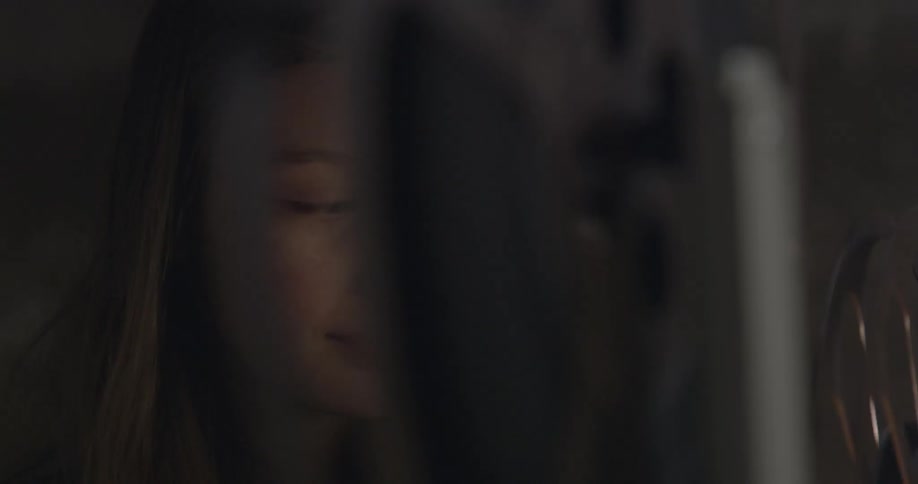 A girl is standing by a projector