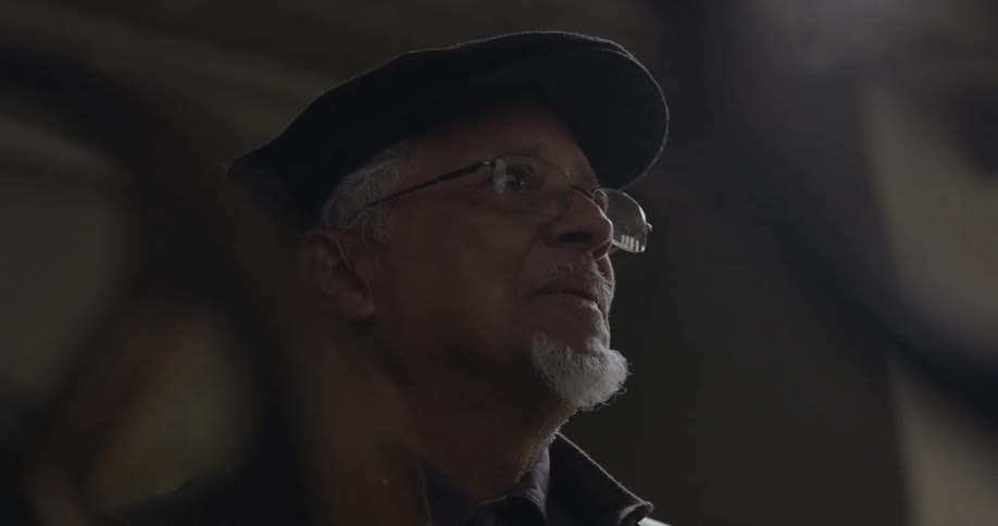 A man is watching something ahead