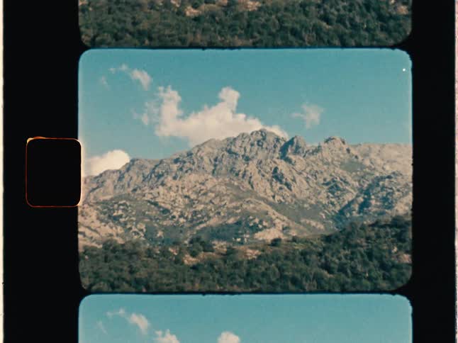Super 8 film of brown rocky mountains during sunny day - overscan
