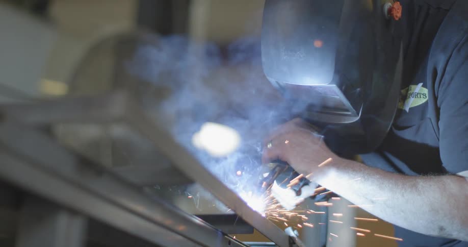 A man is working welding with a mask