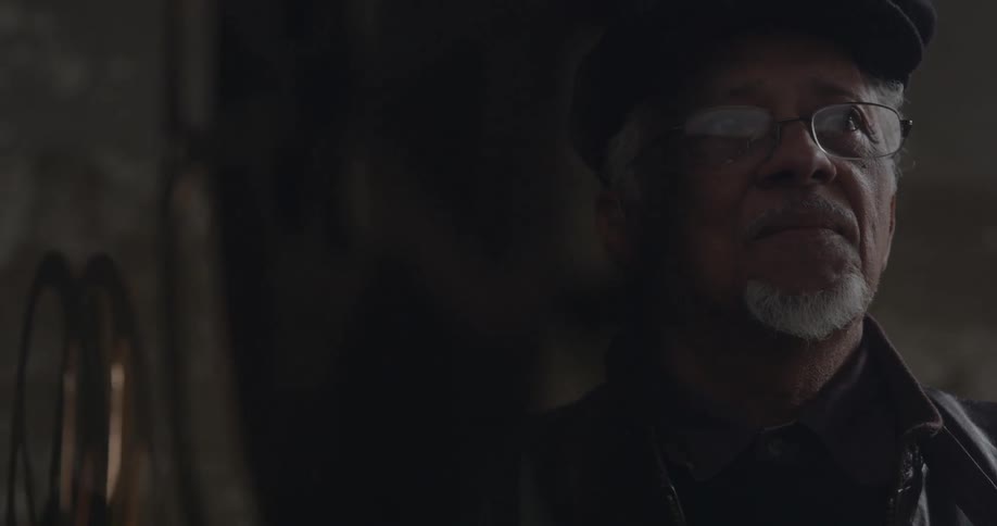 A man looks forward as a projector turns