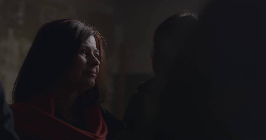 Two women are standing in the dark together