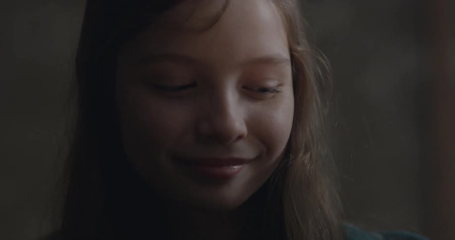 A child is looking around smiling