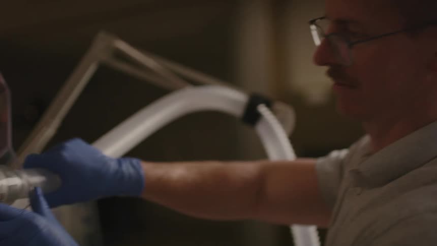 Healthcare technician prepares a patient for a cardiorespiratory stress test