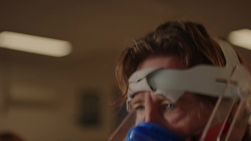 Medical professional adjusts treadmill settings as man runs during vo2 test