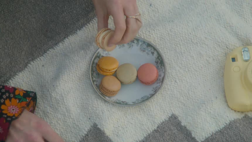 A person throwing cookies away from the bowl on the rug