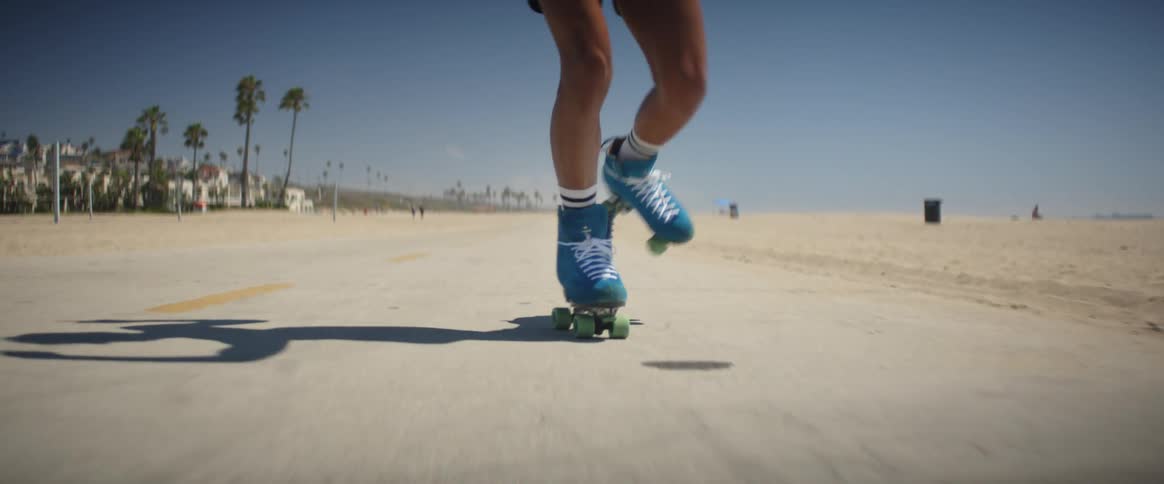 Man rollerblading on the beach sidewalk during the summer