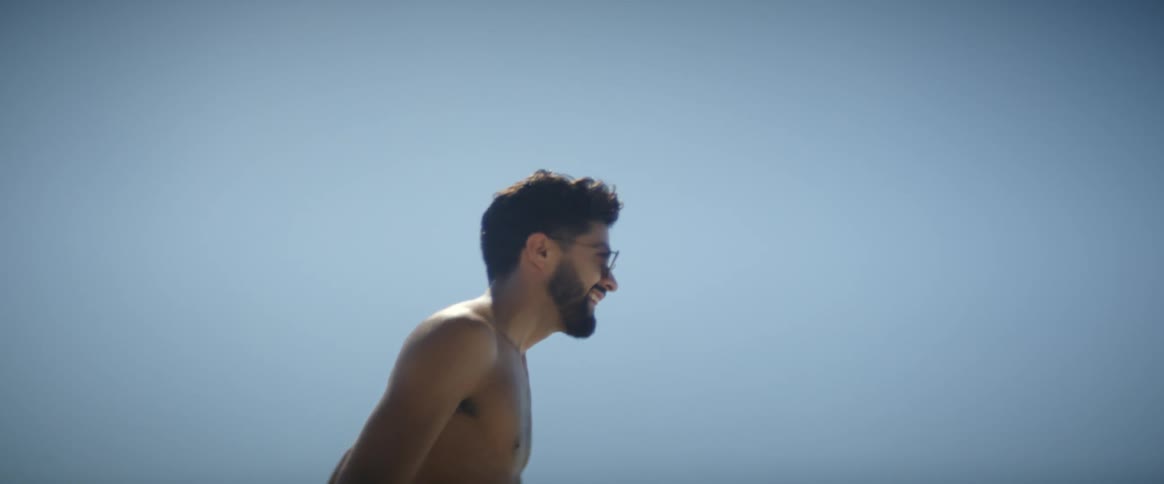 A man is rollerblading on the beach