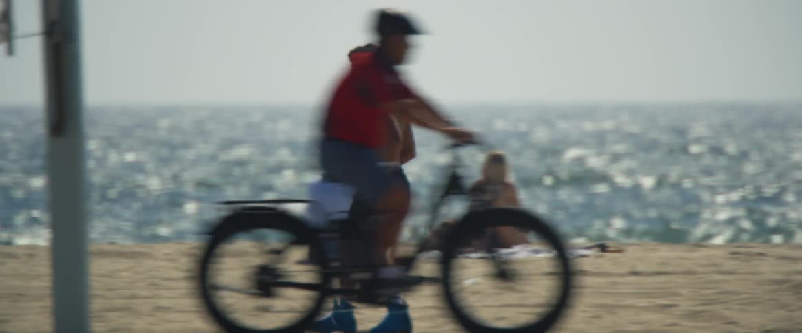 A man skate dancing through the beach