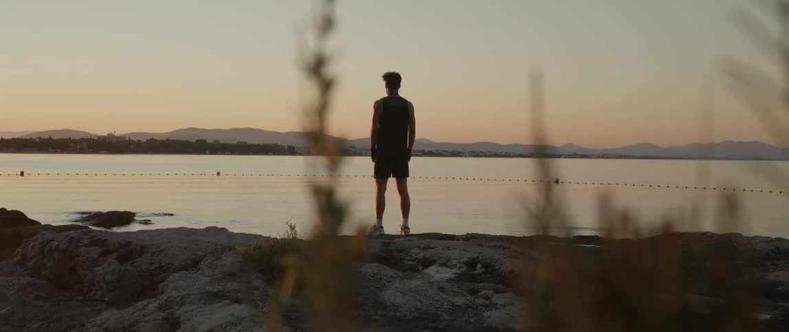 A man is standing by the water