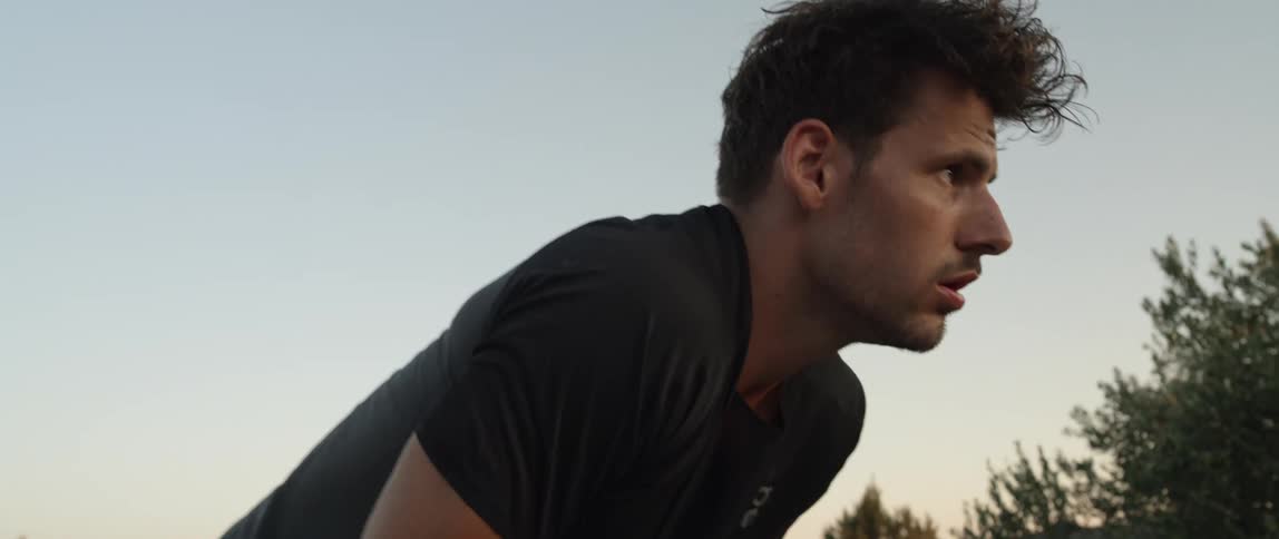 Man stops to rest during a run at sunset