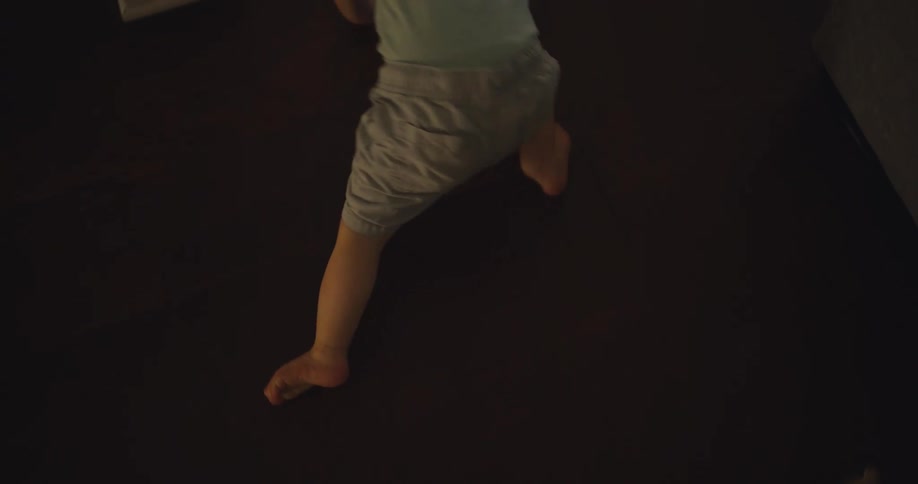 A baby is crawling around the floor