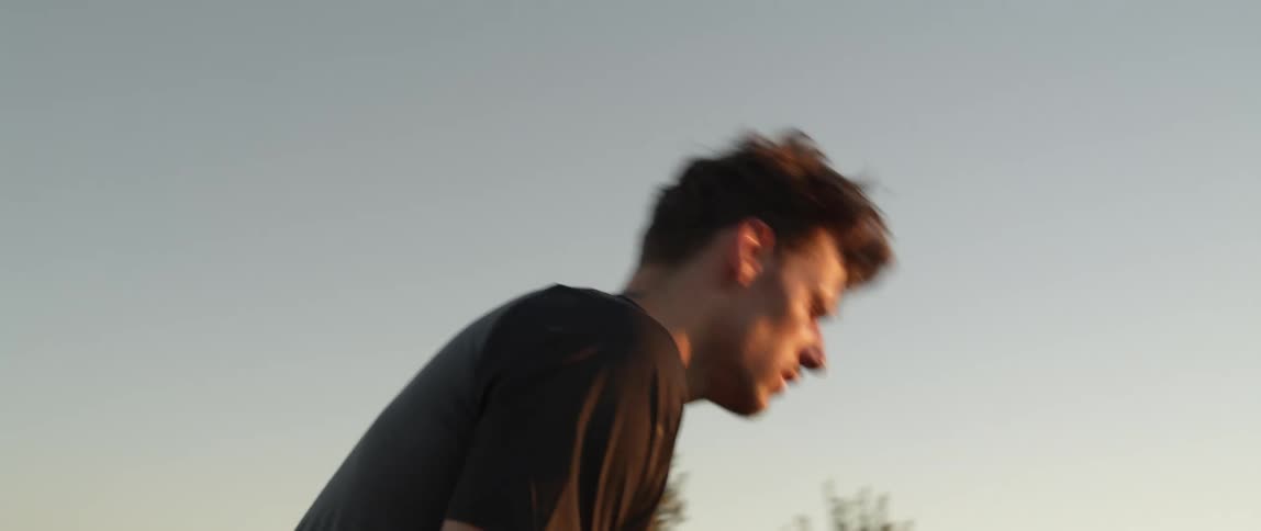 A man saluting the sun while walking