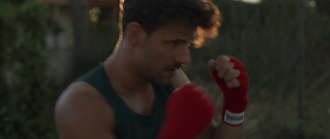 Man boxing alone at sunset