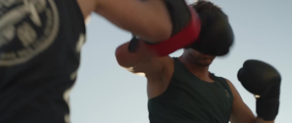 A men having an outdoor boxing training session with a trainer