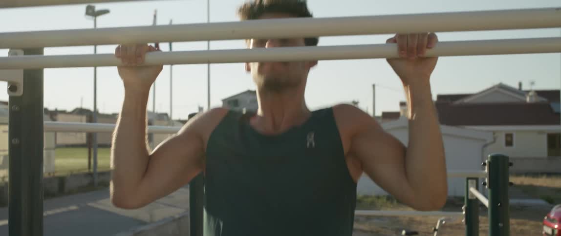 A man is doing pull ups on a bar