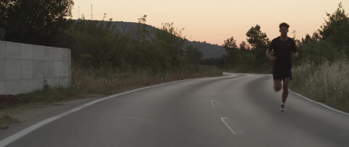 A person running on the lone road