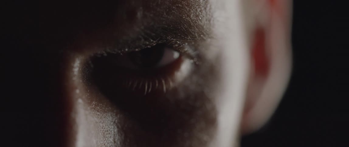 Man opens eye to stare