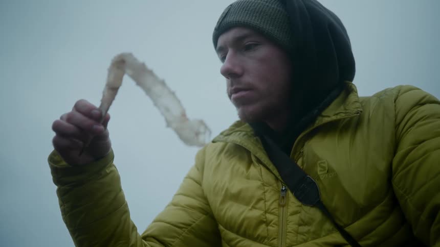 A man examining plastic outdoors