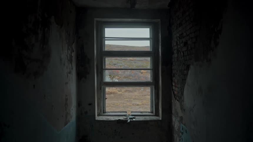 A small room with a small wooden window