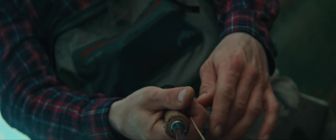 Man sorting white thread with hands indoor