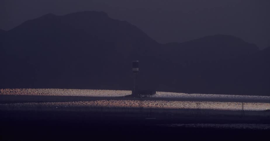 A solar facility at the base of a mountain range