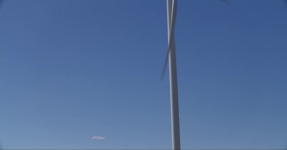 Modern windmills on a grassy field