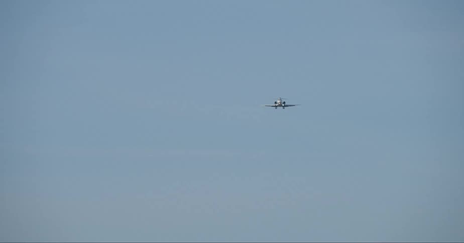 Airplane on approach through blue skies