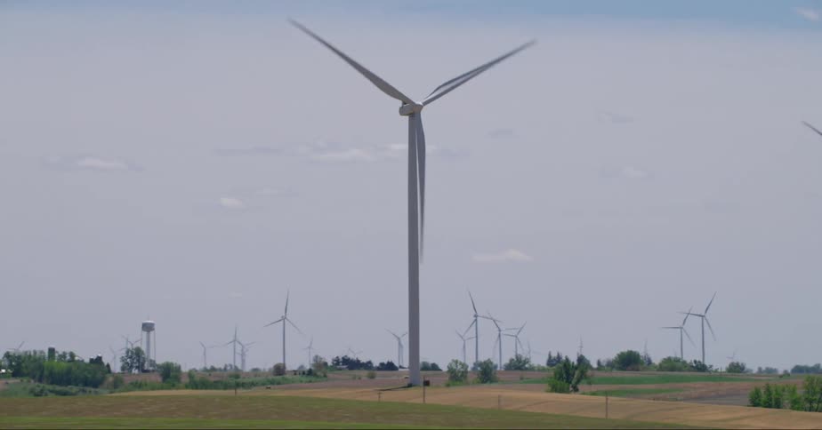 Wind turbines on wind farm seen from vehicle driving on highway
